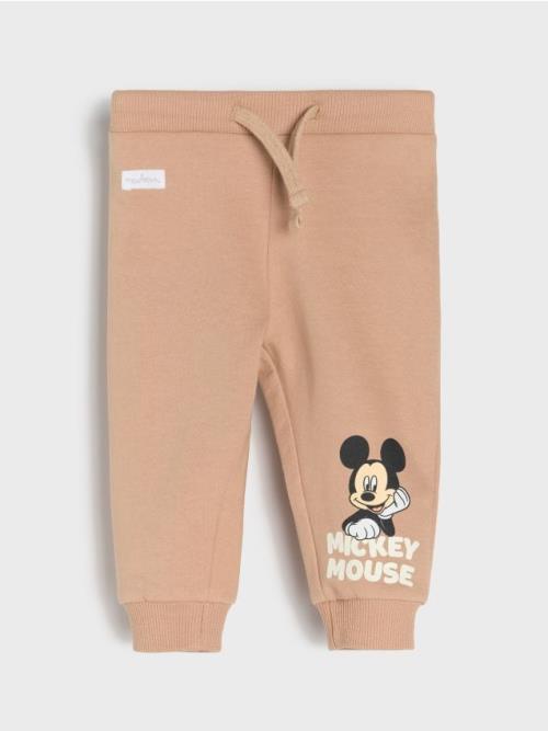 Sinsay - Teplákové nohavice Mickey Mouse - béžová