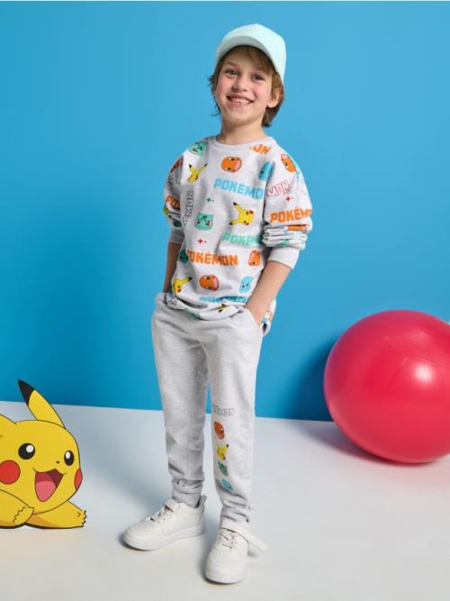 Sinsay - Jogger tepláky Pokémon - svetlošedá